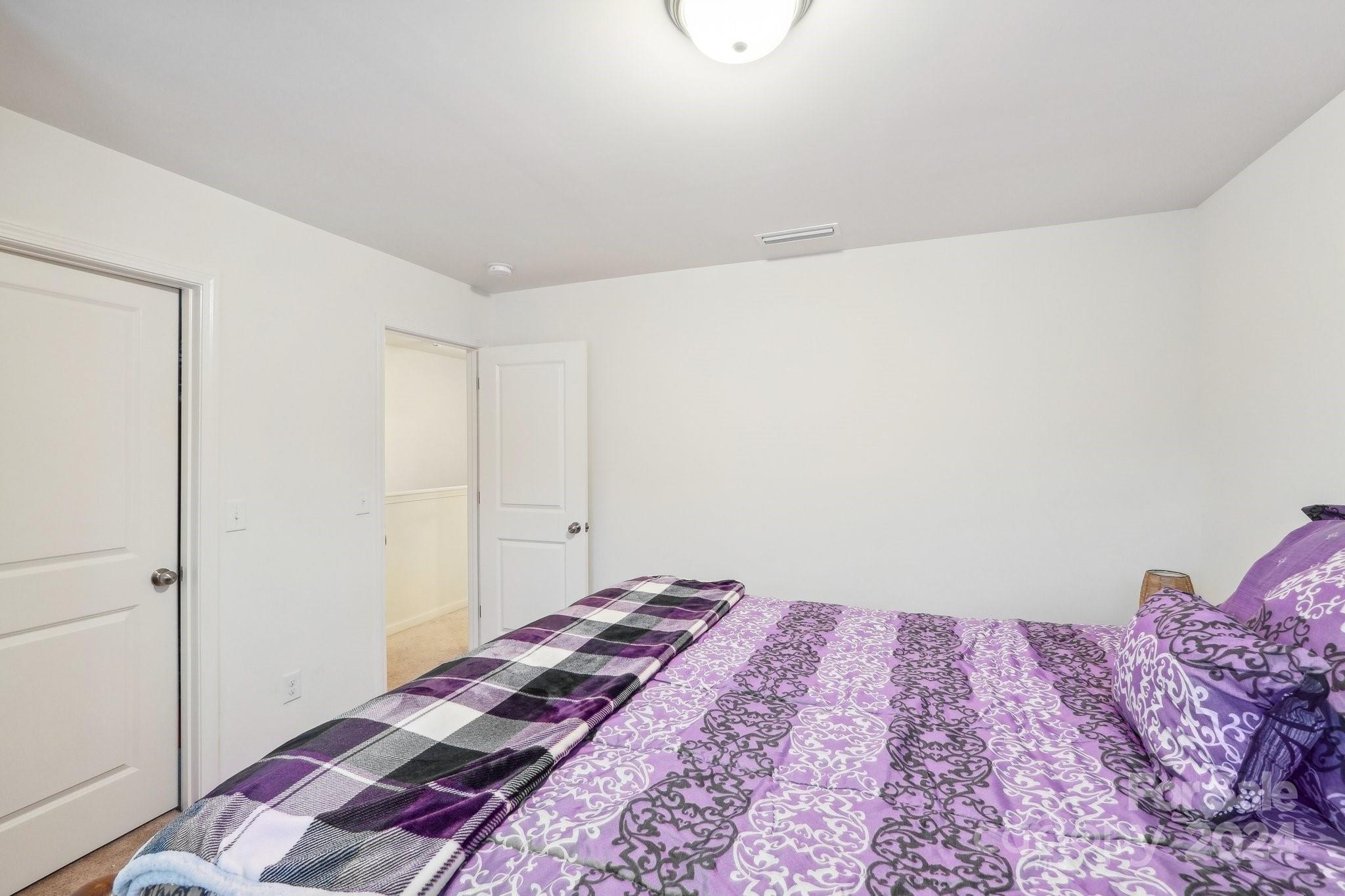 1065 Ramsgate Drive Southwest Concord, NC 28025 - Photo 36 of 47 a bedroom with a bed and a wall painting