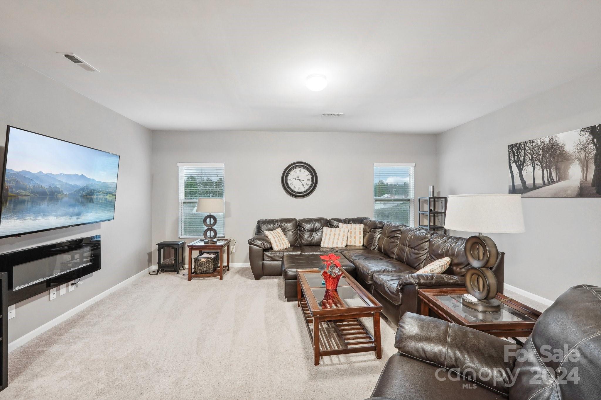 1065 Ramsgate Drive Southwest Concord, NC 28025 - Photo 7 of 47 a living room with furniture a flat screen tv and a window