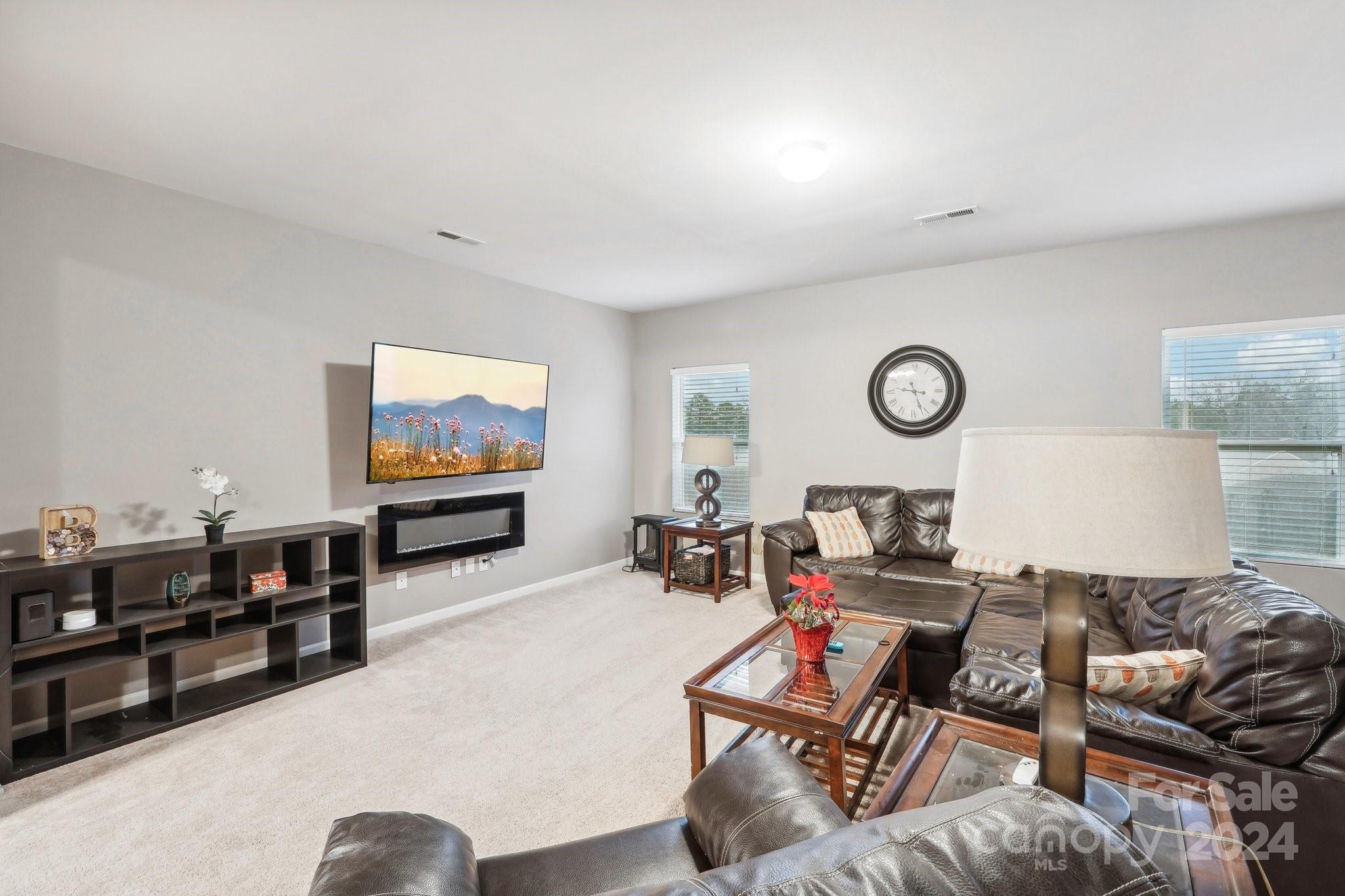 1065 Ramsgate Drive Southwest Concord, NC 28025 - Photo 9 of 47 a living room with furniture and a flat screen tv