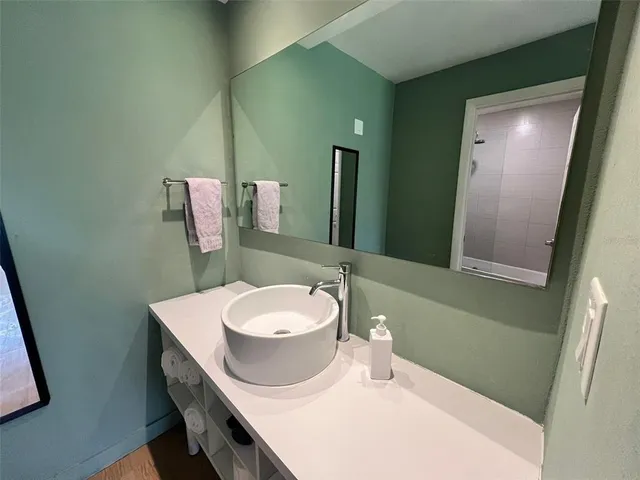 a bathroom with a sink a toilet and mirror