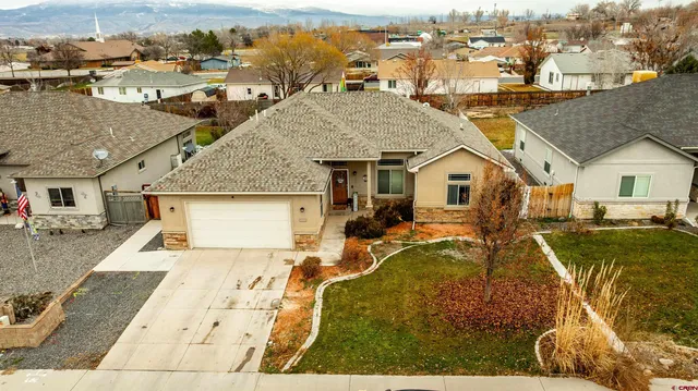an aerial view of a house with a yard table and chairs
