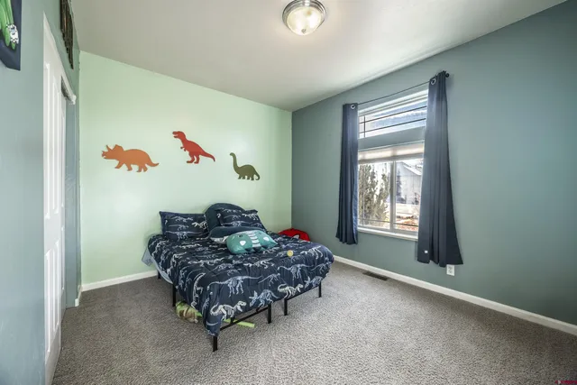 a bed sitting in a room next to a window