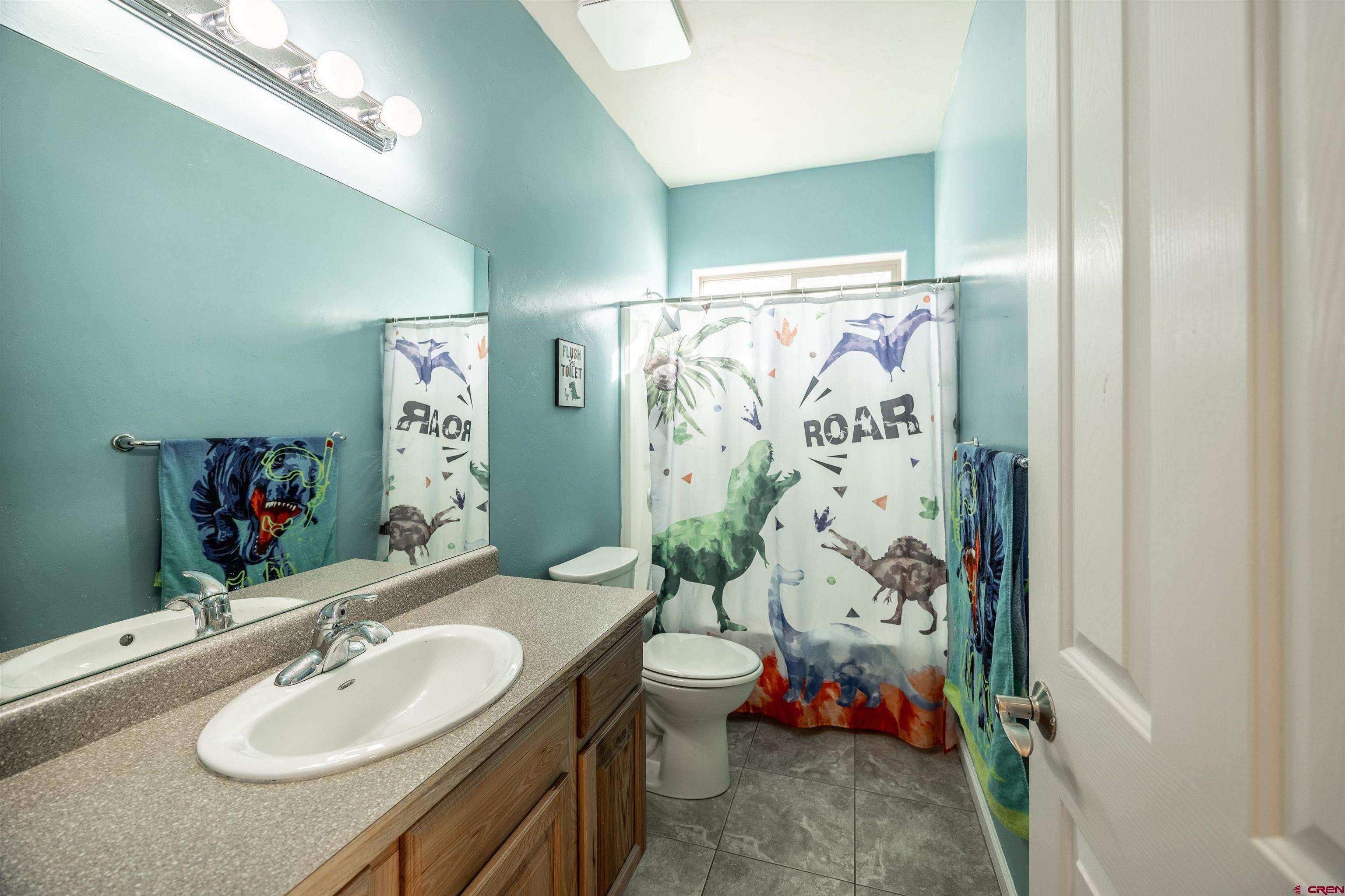 1443 Criterion Street Delta, CO 81416 - Photo 17 of 36 a bathroom with a sink and a mirror