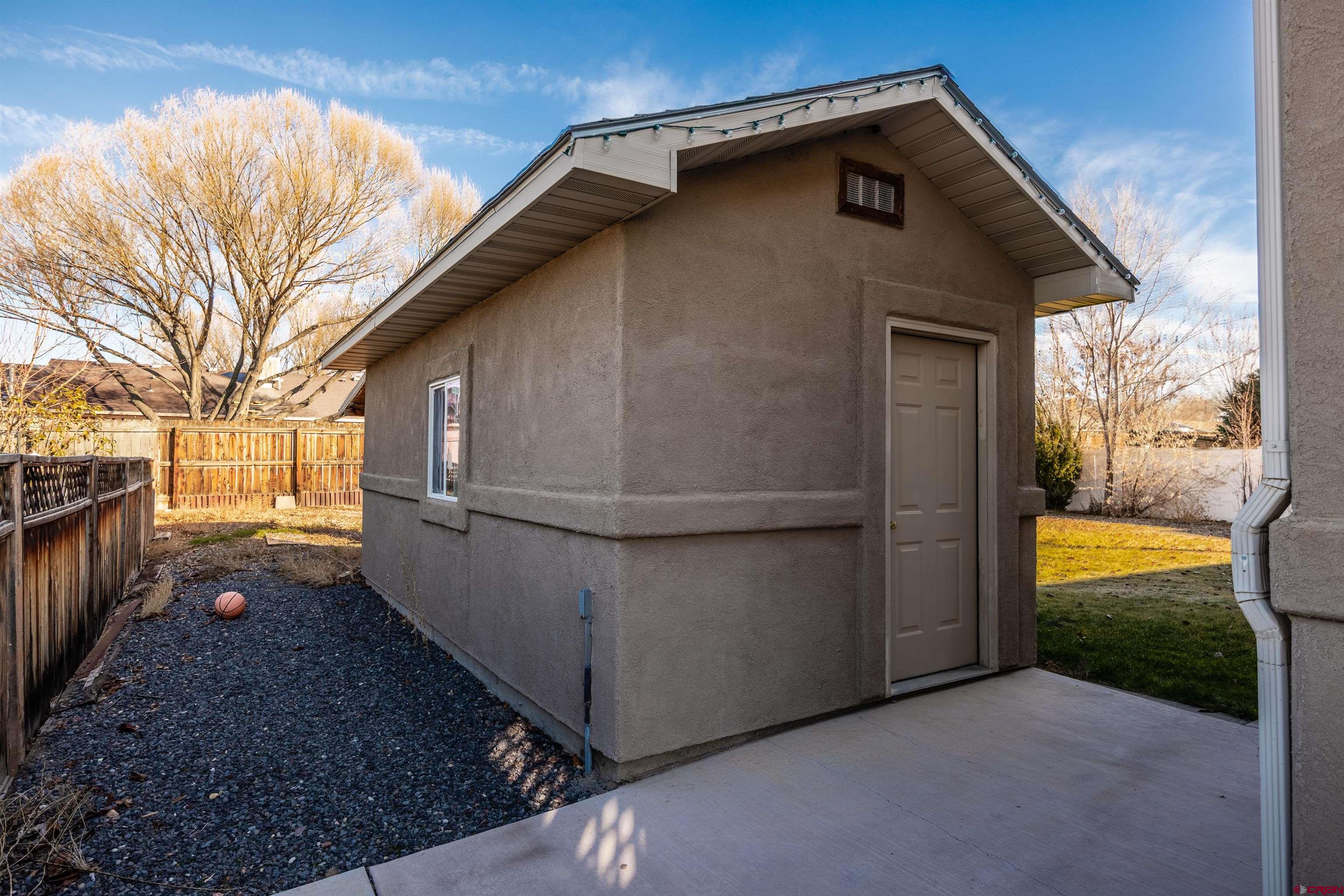 1443 Criterion Street Delta, CO 81416 - Photo 22 of 36 a backyard of a house with a yard and garage