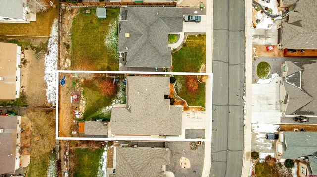 an aerial view of residential house with outdoor space and parking