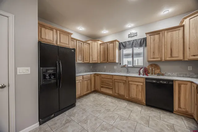 a kitchen with stainless steel appliances granite countertop a refrigerator and cabinets