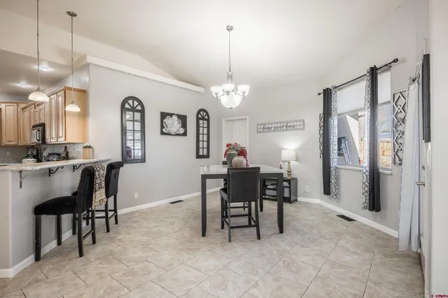 a view of a dining room with furniture and a chandelier