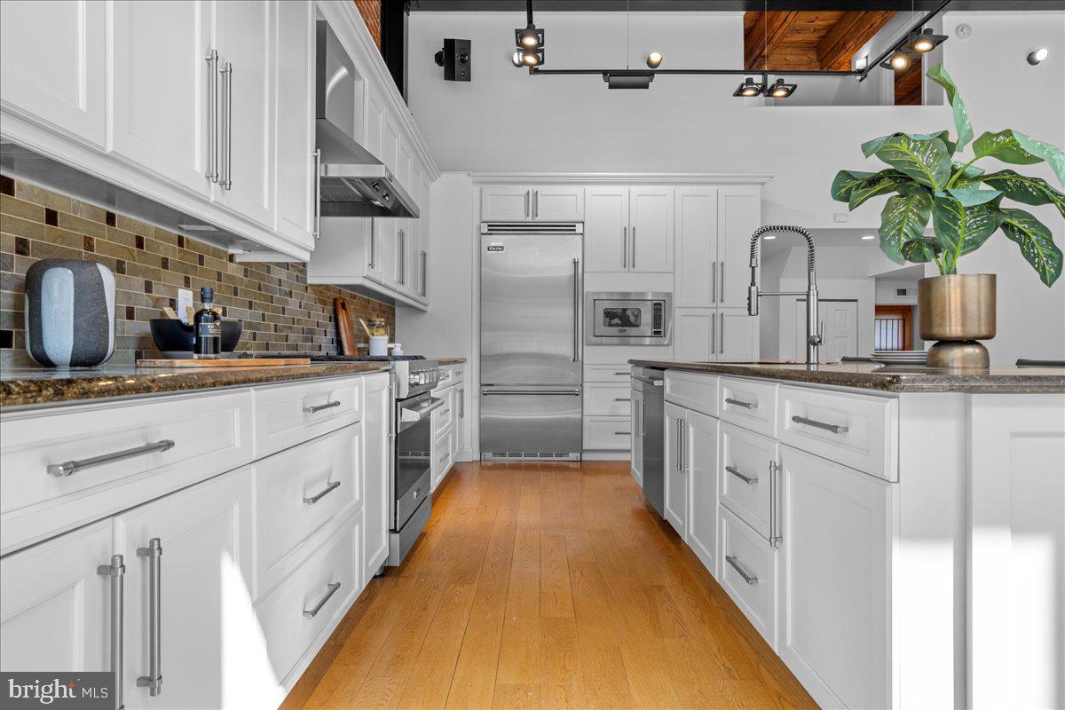 314 Fitzwater Street Philadelphia, PA 19147 - Photo 12 of 51 a kitchen with white cabinets and white appliances