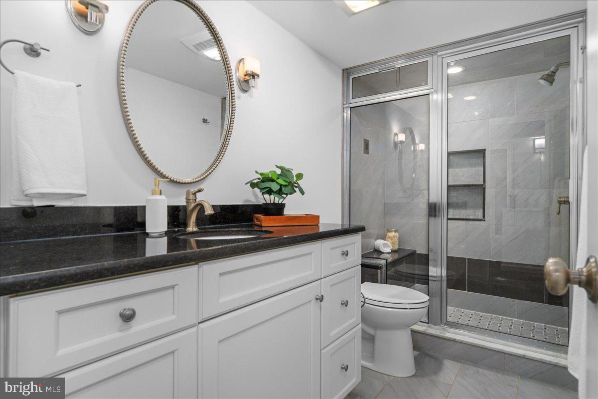314 Fitzwater Street Philadelphia, PA 19147 - Photo 23 of 51 a bathroom with a toilet a sink and a mirror