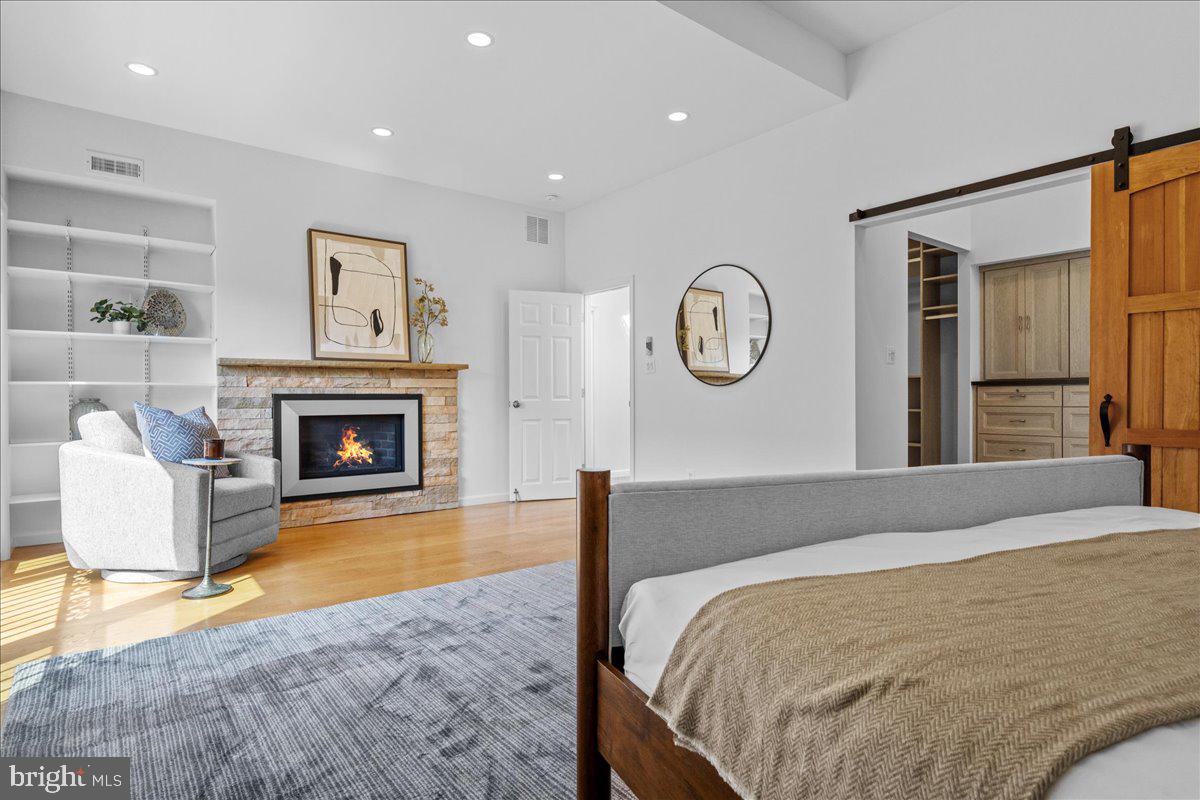 314 Fitzwater Street Philadelphia, PA 19147 - Photo 28 of 51 a spacious bedroom with a large bed and a fireplace