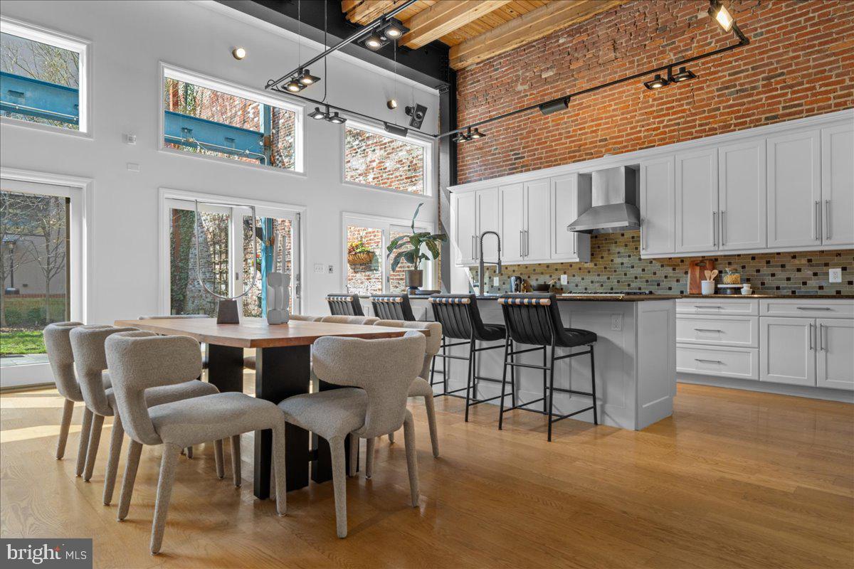 314 Fitzwater Street Philadelphia, PA 19147 - Photo 3 of 51 a dining area with stainless steel appliances kitchen island granite countertop a dining table chairs and a white refrigerator