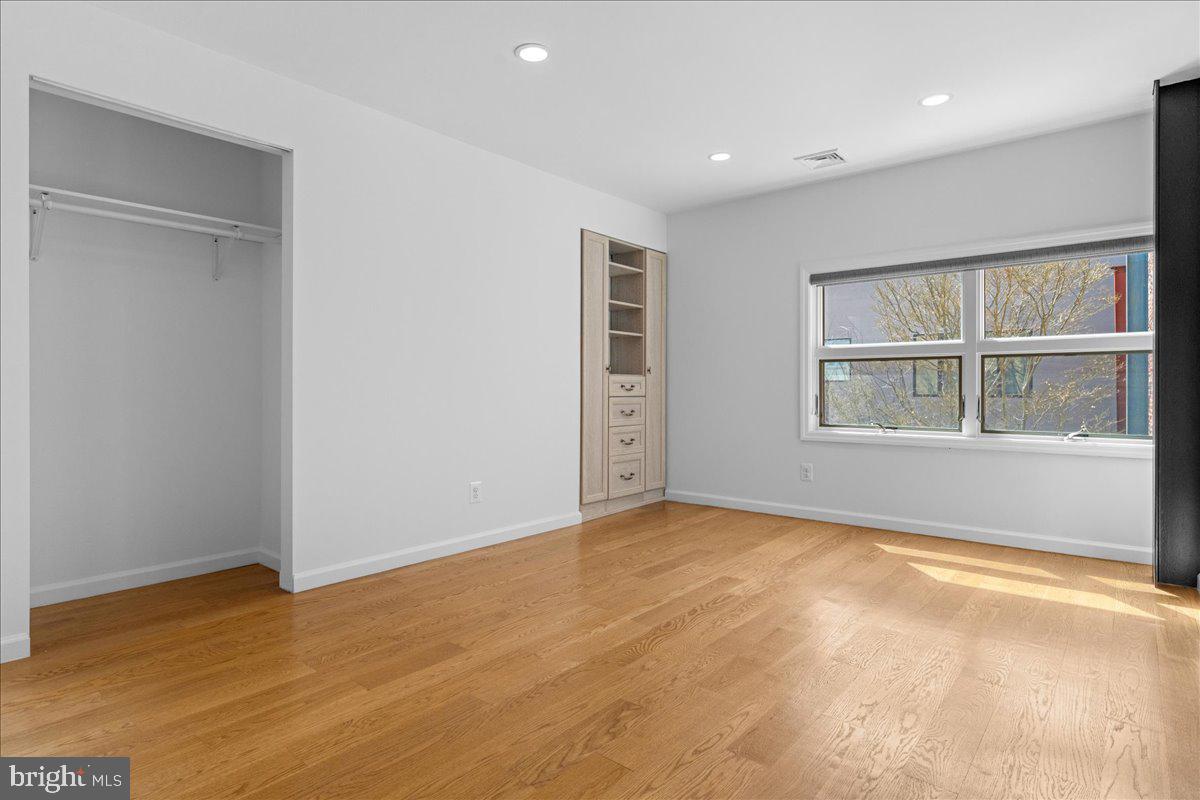 314 Fitzwater Street Philadelphia, PA 19147 - Photo 42 of 51 an empty room with wooden floor and windows