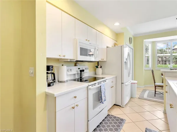 a kitchen with a sink a stove a refrigerator and cabinets