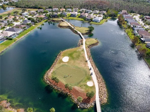 an aerial view of a house with a yard and lake view