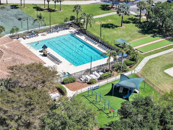 an aerial view of a house with a garden and swimming pool
