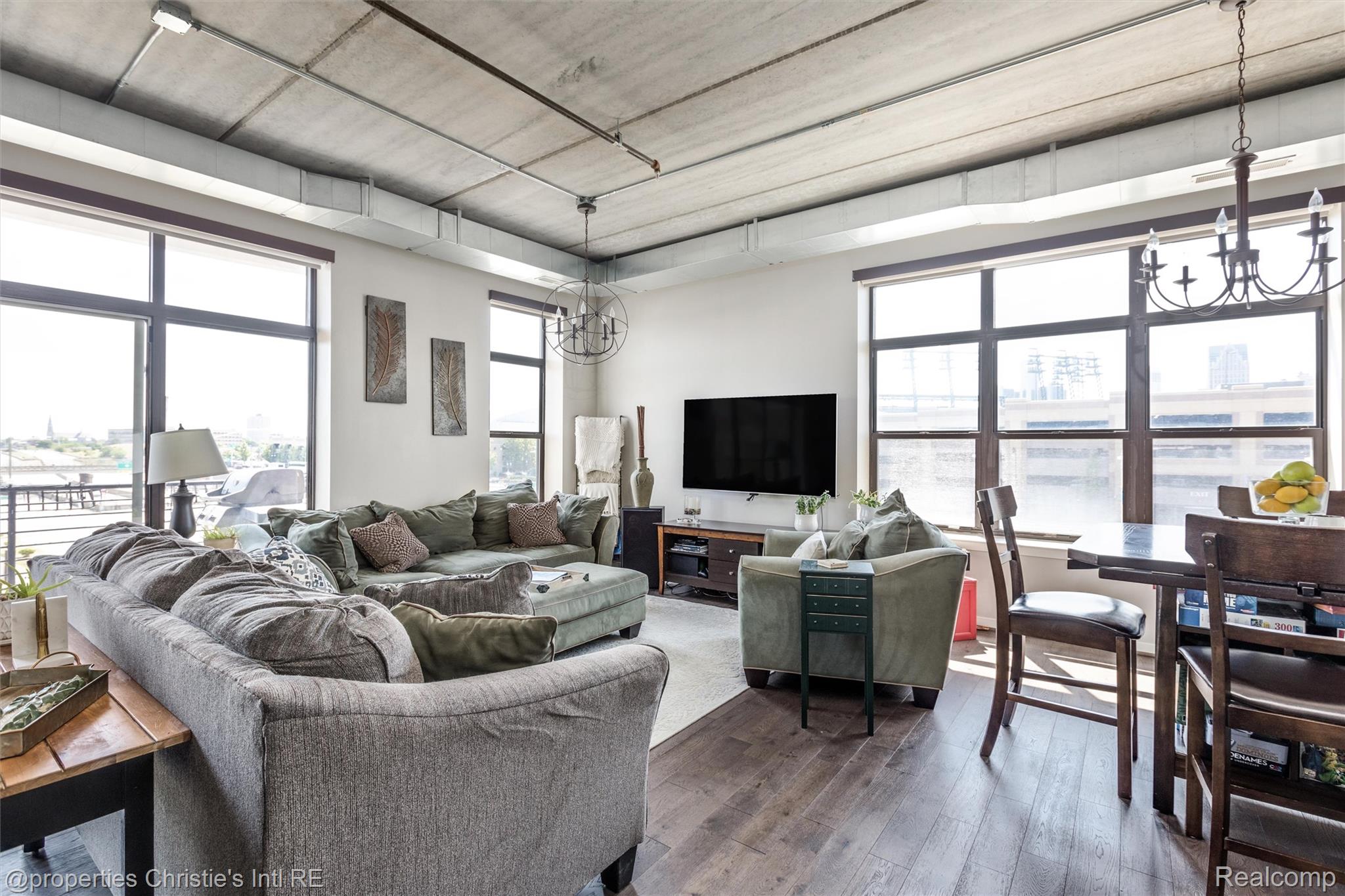 66 Winder Street, Unit 332 Detroit, MI 48201 - Photo 5 of 30 Living room featuring hanging lights and wood-type flooring