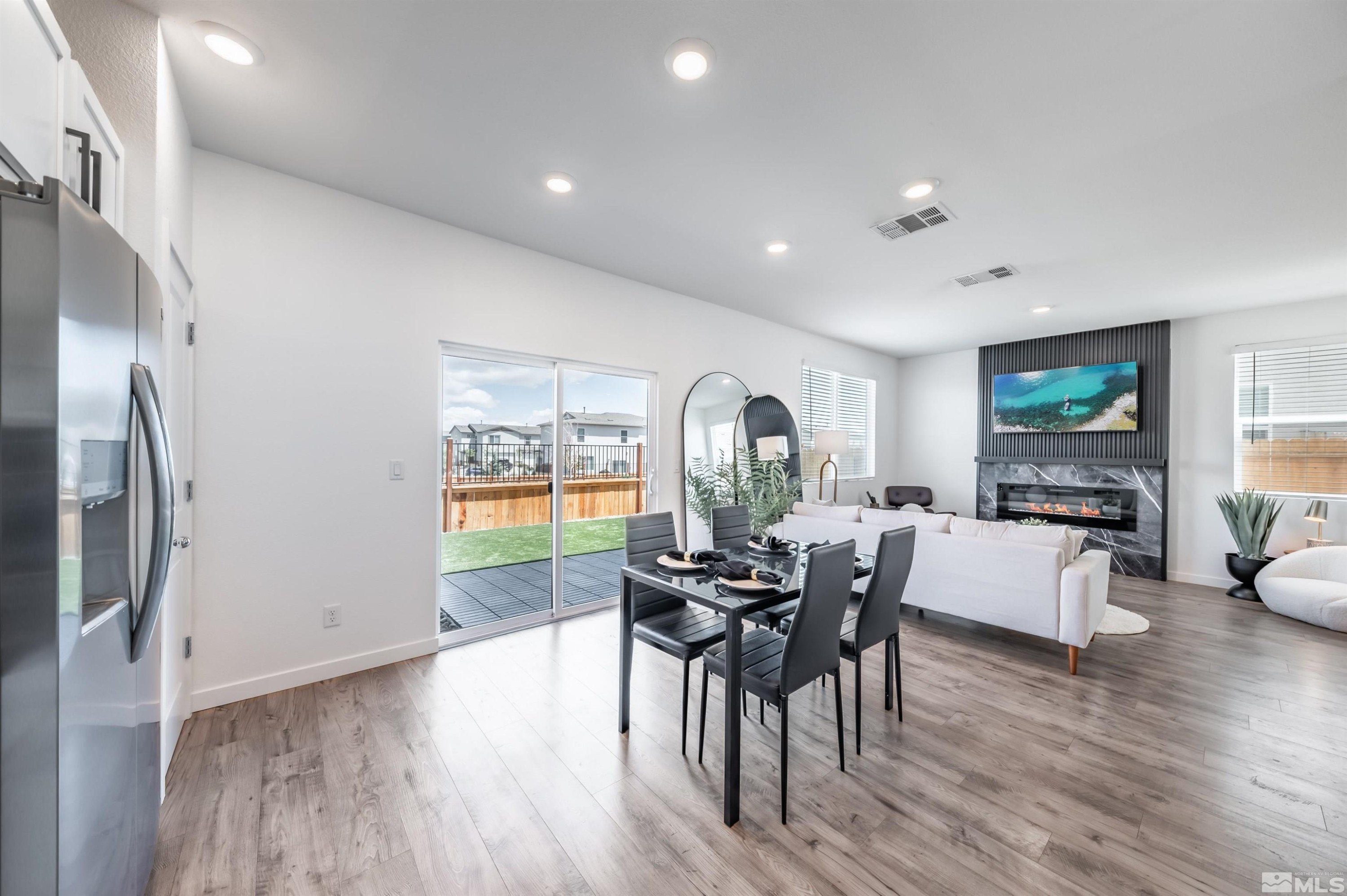8855 Wolf Moon Drive Reno, NV 89506 - Photo 11 of 35 a living room with furniture a large window and a flat screen tv