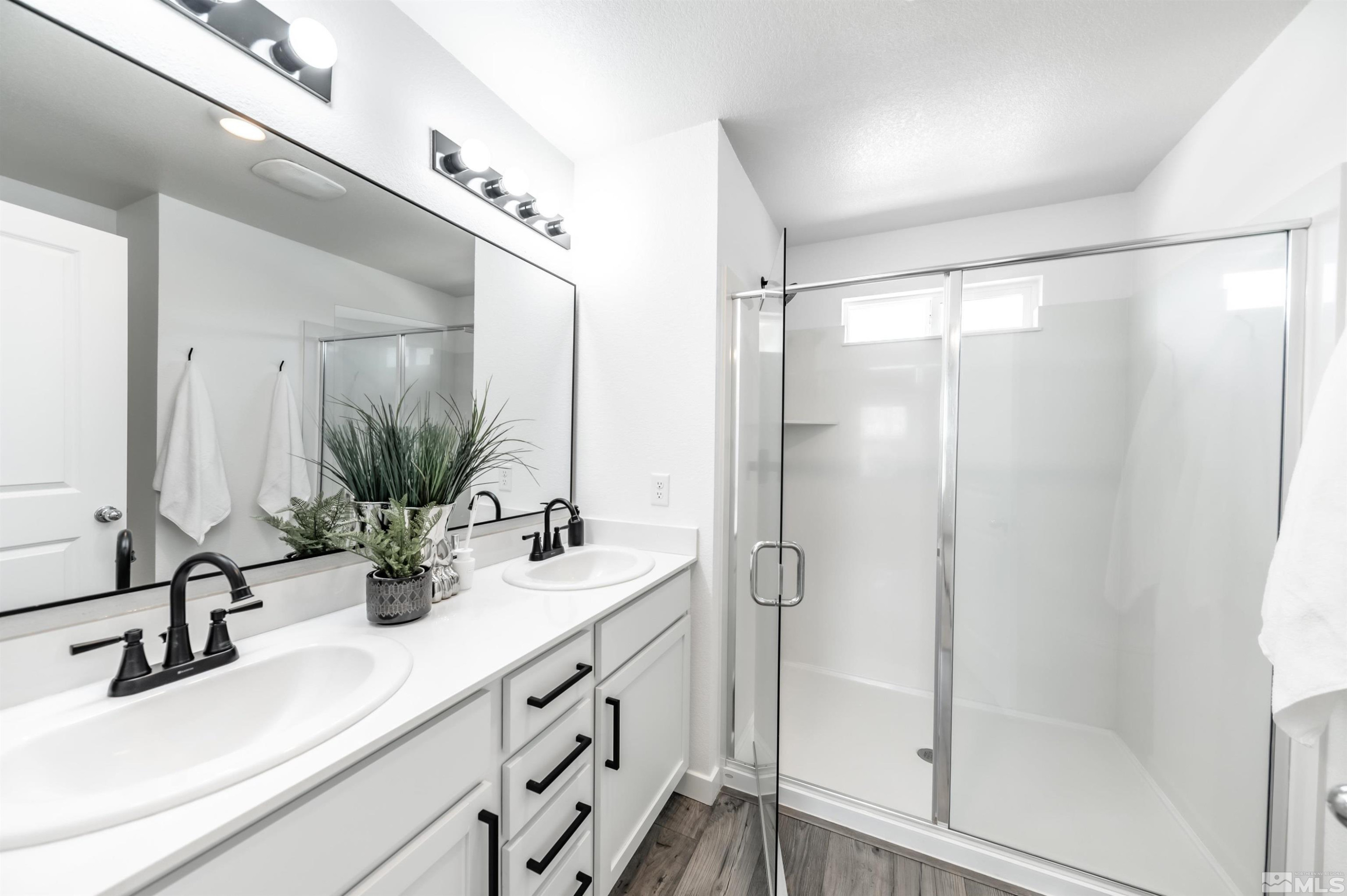 8855 Wolf Moon Drive Reno, NV 89506 - Photo 18 of 35 a bathroom with double vanity sink and mirror