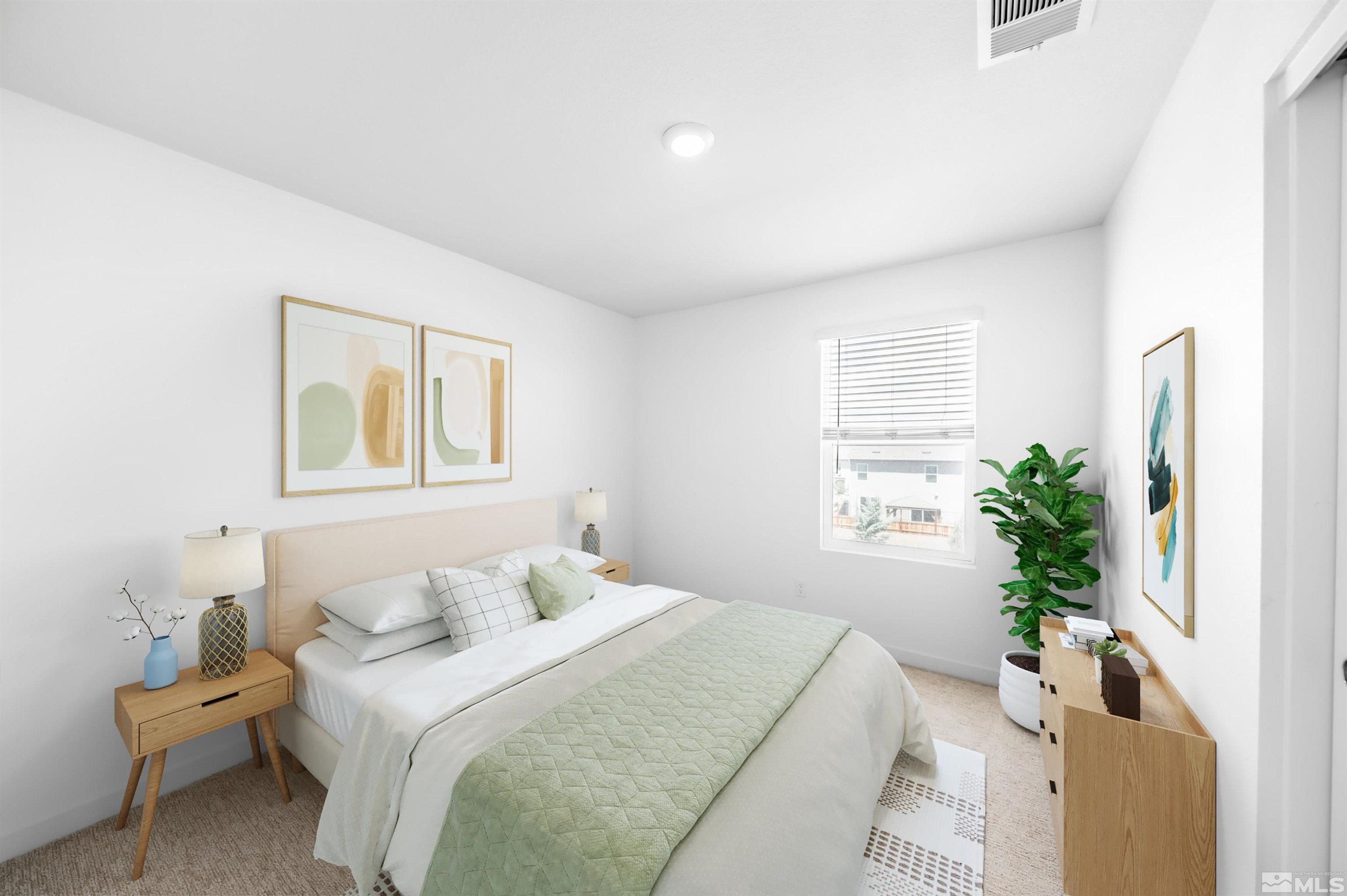 8855 Wolf Moon Drive Reno, NV 89506 - Photo 21 of 35 a bedroom with a large bed and a potted plant