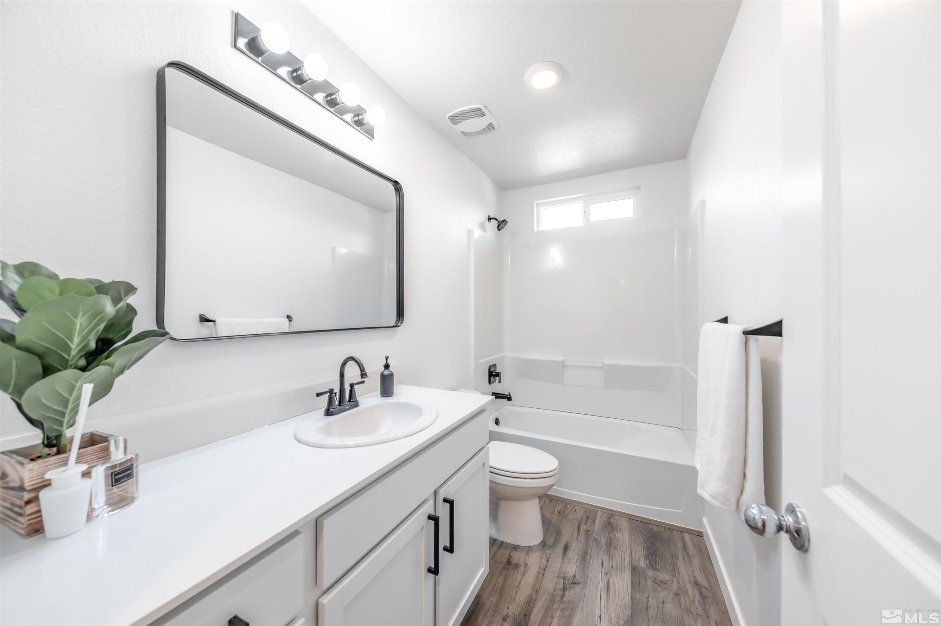 8855 Wolf Moon Drive Reno, NV 89506 - Photo 26 of 35 a bathroom with a bathtub shower sink vanity mirror and toilet