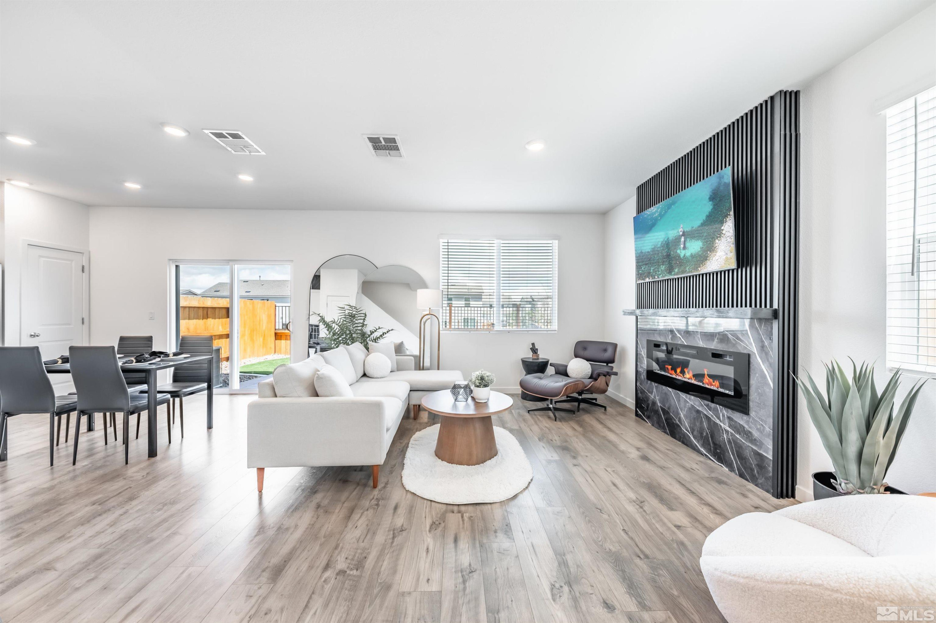 8855 Wolf Moon Drive Reno, NV 89506 - Photo 3 of 35 a living room with furniture fireplace and wooden floor