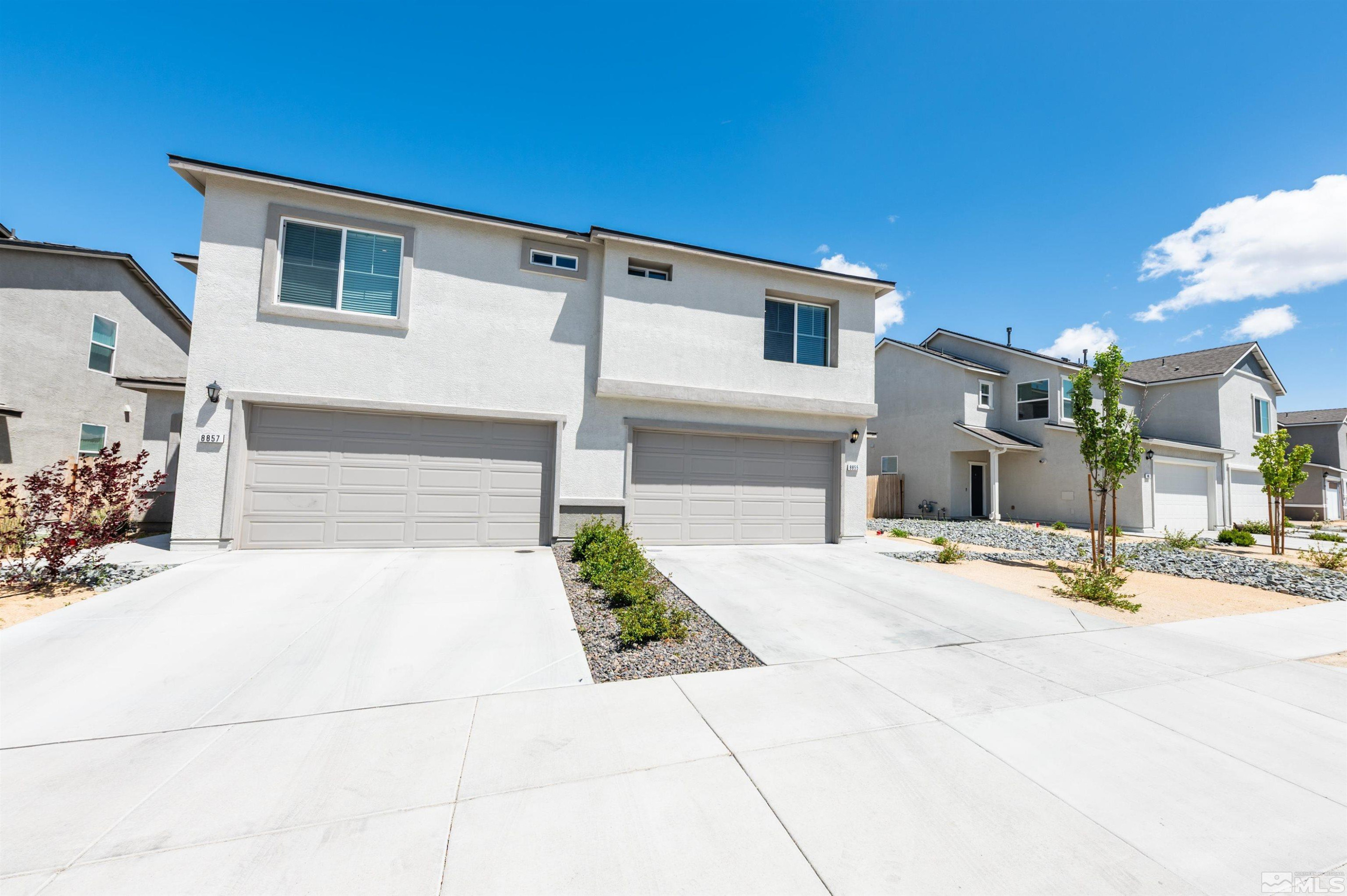 8855 Wolf Moon Drive Reno, NV 89506 - Photo 33 of 35 a front view of a house with a yard and garage