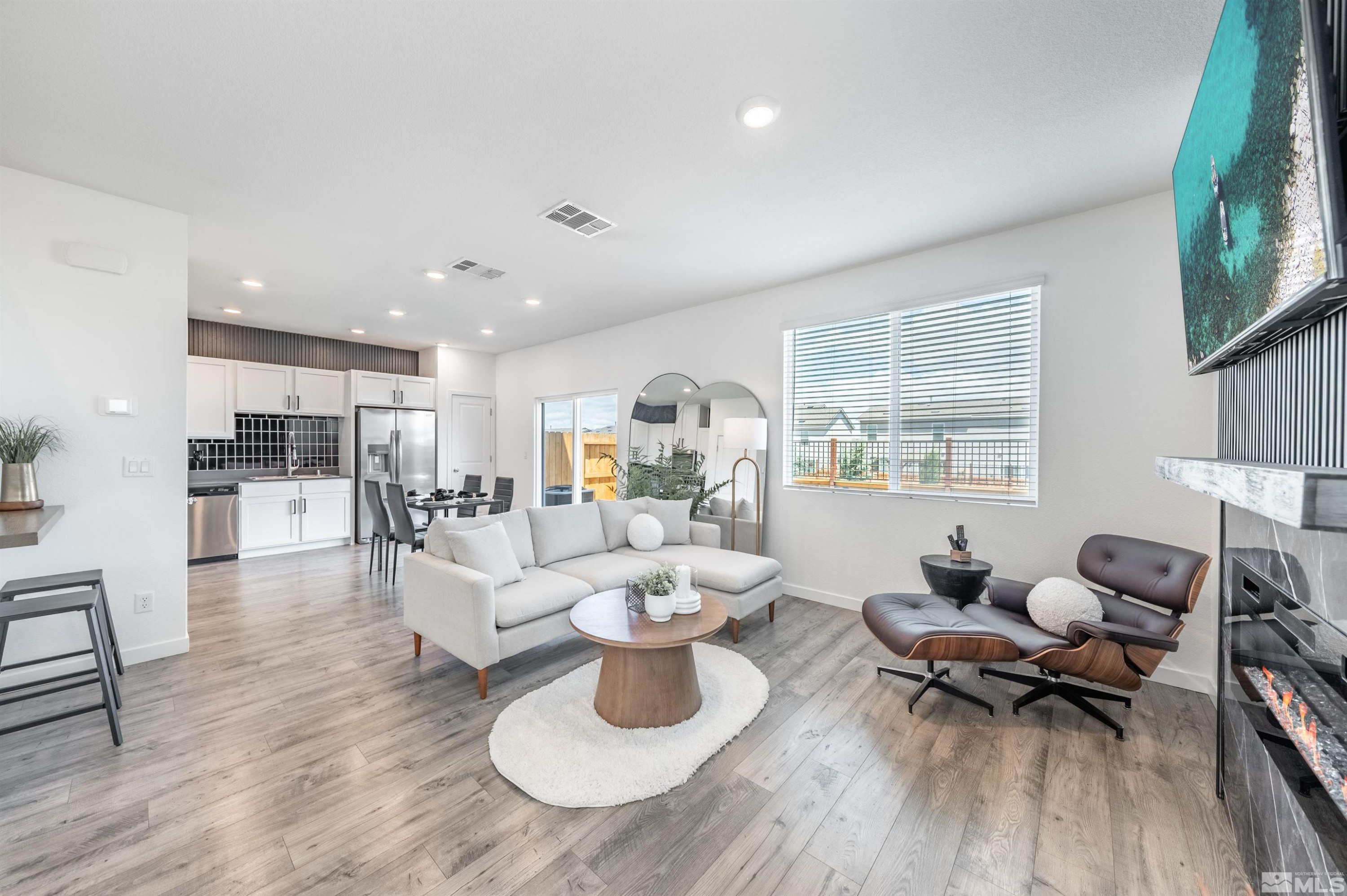 8855 Wolf Moon Drive Reno, NV 89506 - Photo 4 of 35 a living room with furniture and a wooden floor