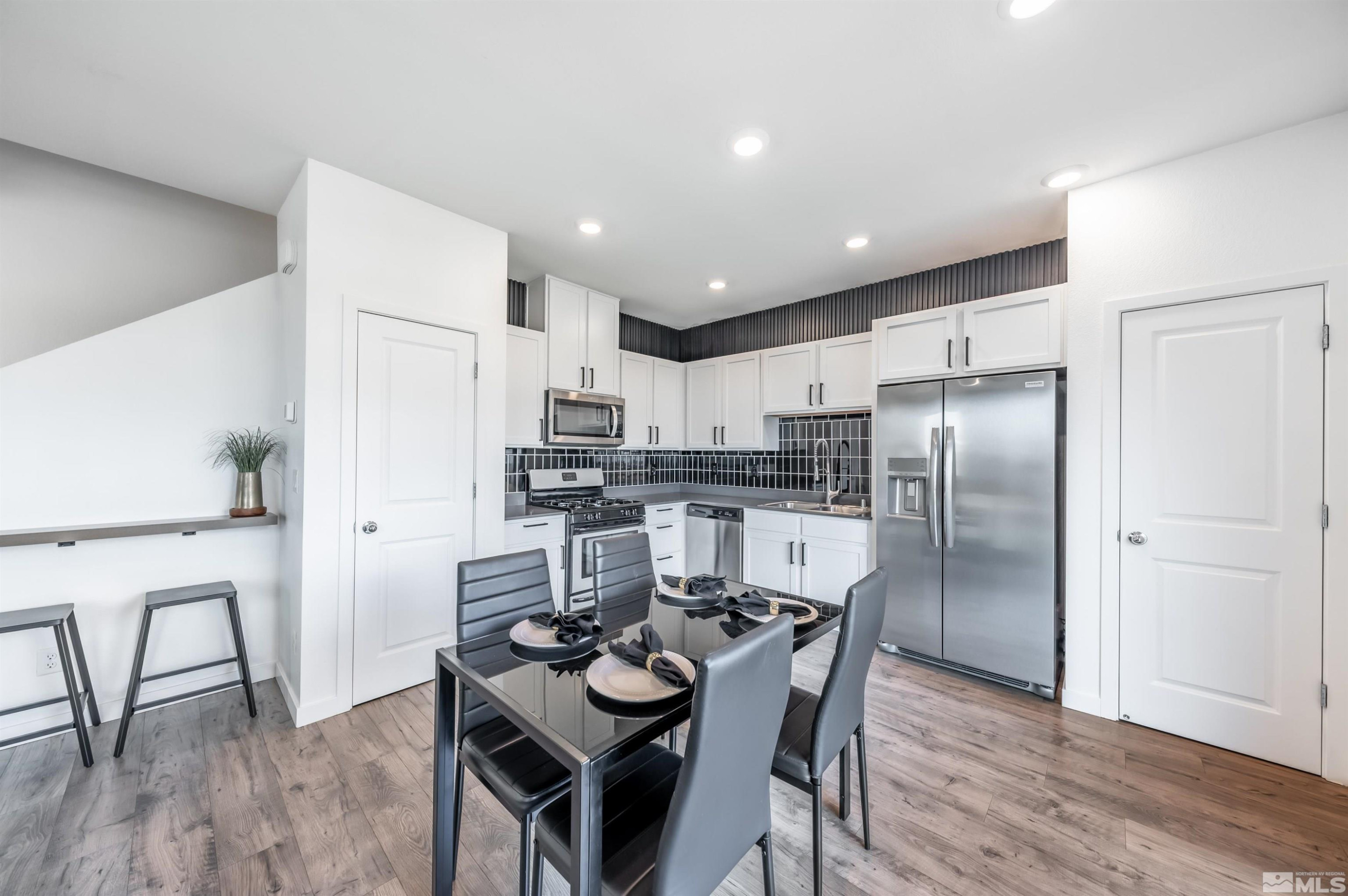 8855 Wolf Moon Drive Reno, NV 89506 - Photo 9 of 35 a kitchen with refrigerator and chairs