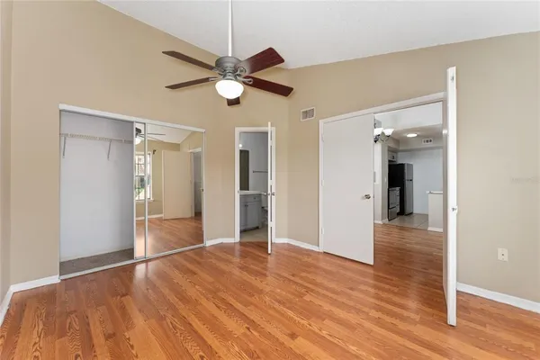 a view of empty room with wooden floor