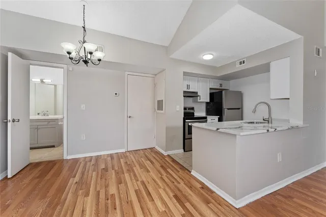 a view of kitchen with sink microwave and refrigerator
