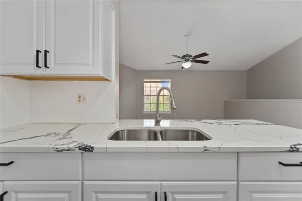 a kitchen with a sink and cabinets
