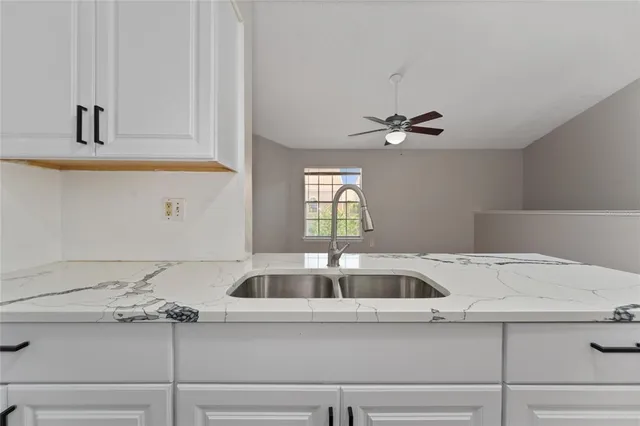 a kitchen with a sink and cabinets