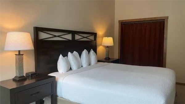 a bedroom with a bed and a desk
