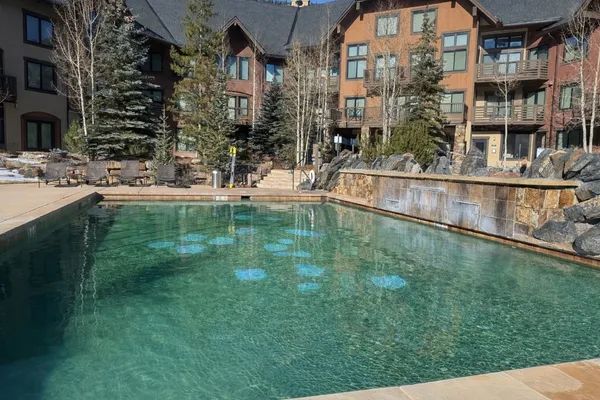 a swimming pool view with outdoor seating