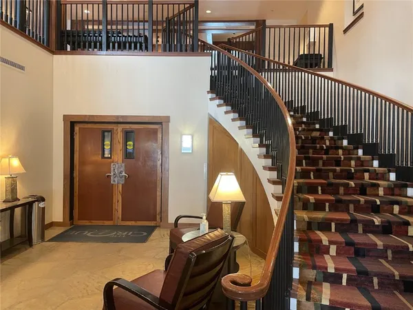 a view of a livingroom with furniture and staircase