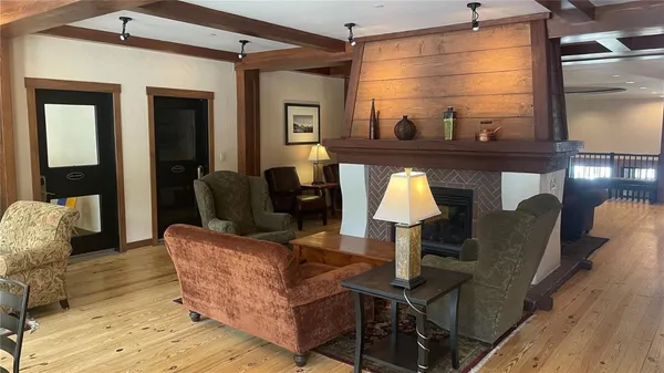 a living room with furniture and a lamp