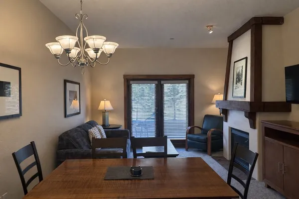 a living room with fireplace furniture and a wooden floor