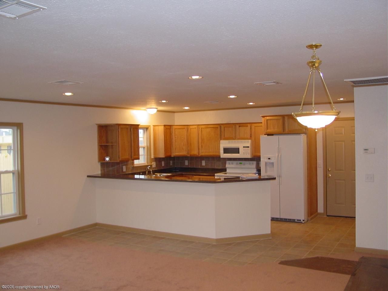 4414 South Austin Street Amarillo, TX 79110 - Photo 2 of 7 a kitchen with stainless steel appliances granite countertop a sink and a refrigerator