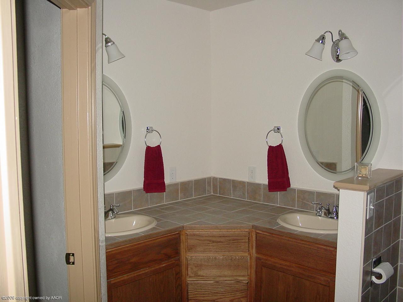 4414 South Austin Street Amarillo, TX 79110 - Photo 6 of 7 a bathroom with a sink and a mirror