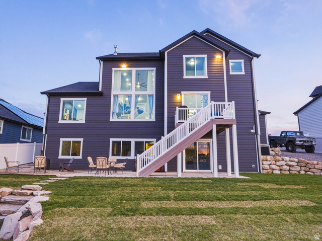 2487 Canyon Wild Road, Unit 413 Draper, UT 84020 - Photo 66 of 75 Rear view of house with a patio, a lawn, and a balcony