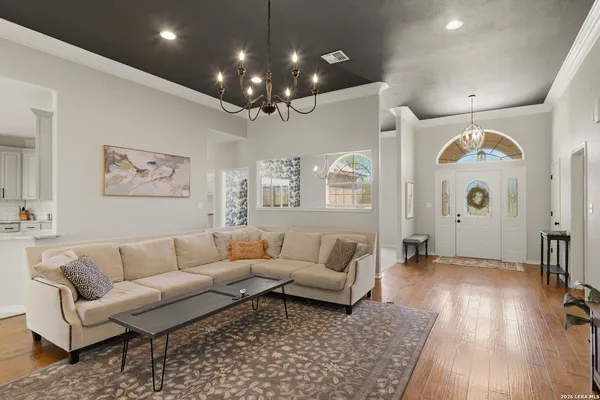 a living room with furniture and wooden floor