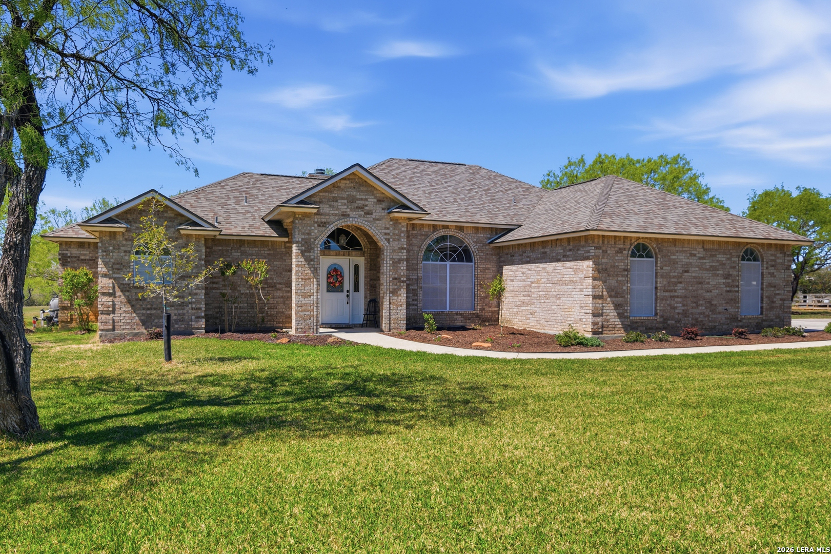 105 Old Campbell Road Seguin, TX 78155 - Photo 2 of 49 a front view of a house with a garden