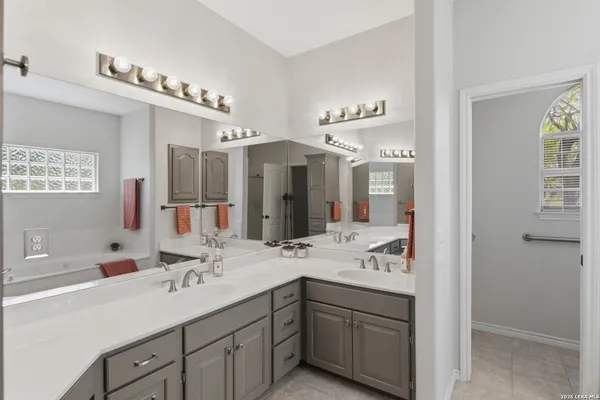 a bathroom with a sink double vanity and a mirror