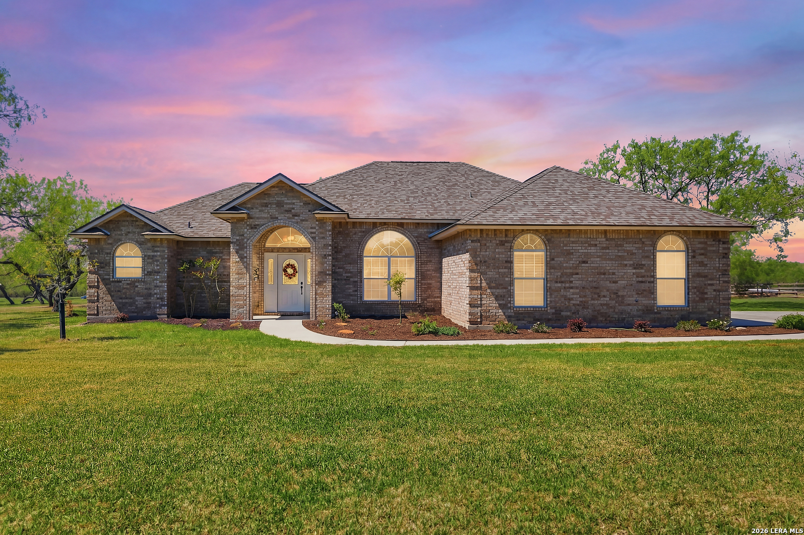 105 Old Campbell Road Seguin, TX 78155 - Photo 3 of 49 a front view of a house with a garden and porch