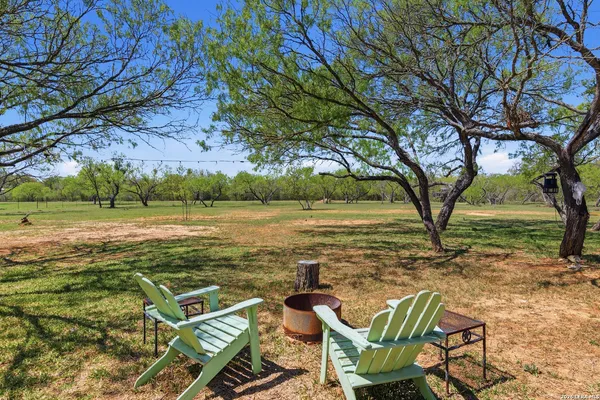 a view of a patio with lawn chairs under an umbrella