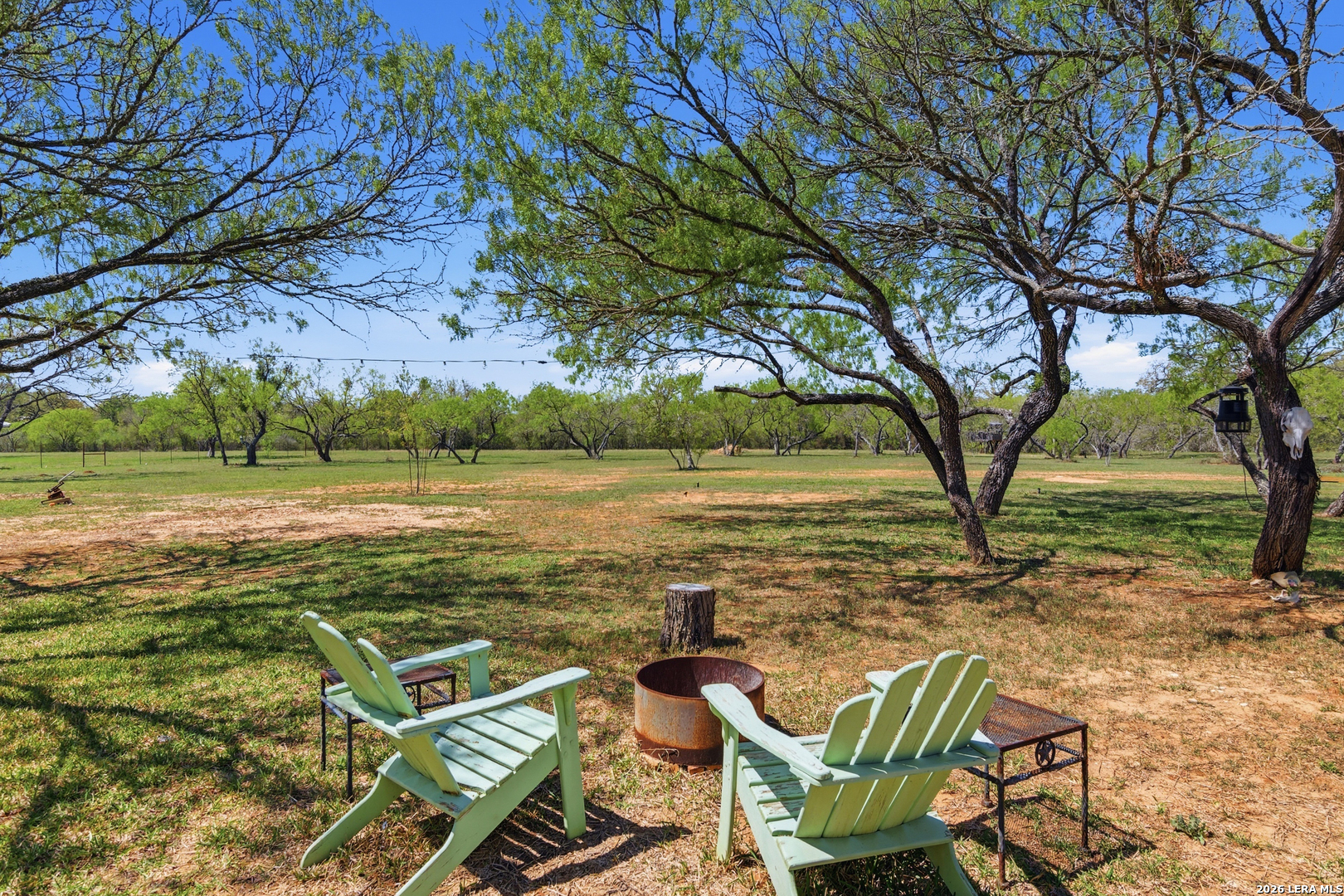 105 Old Campbell Road Seguin, TX 78155 - Photo 39 of 49 a view of a patio with lawn chairs under an umbrella