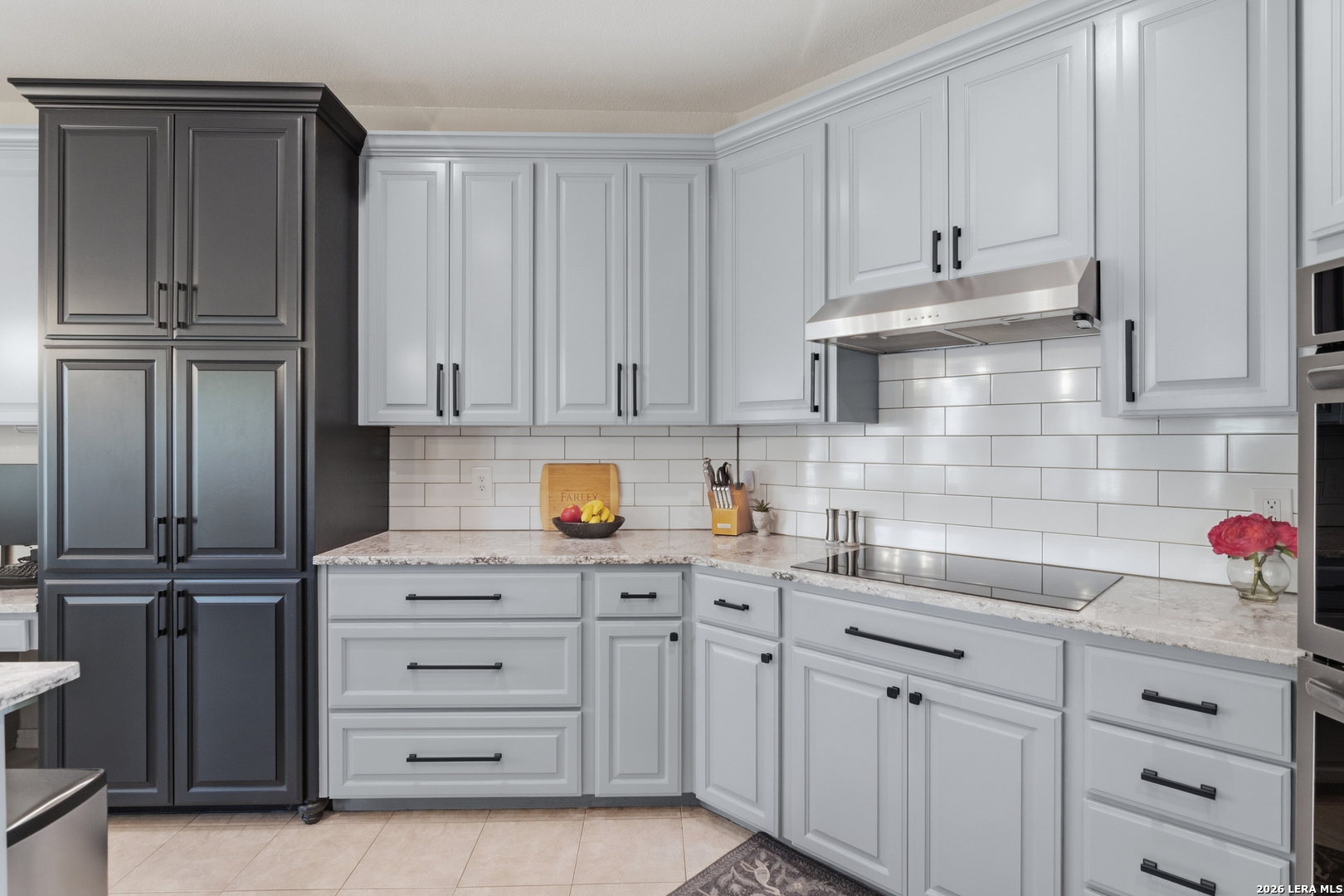 105 Old Campbell Road Seguin, TX 78155 - Photo 10 of 49 a kitchen with white cabinets and black appliances