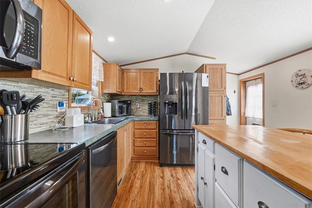 6129 Memorial Road Allentown, PA 18104 - Photo 20 of 46 Warm wood cabinetry and an inviting breakfast island anchor this functional workspace.