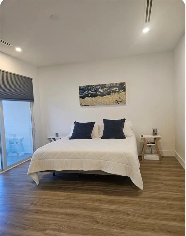 2275 Southeast 7th Street Pompano Beach, FL 33062 - Photo 11 of 14 a bedroom with a bed and wooden floor