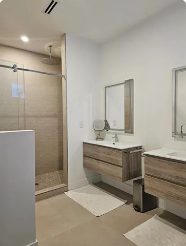 a view of bathroom with bathtub shower and mirror